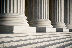 Abstract view of neoclassical fluted columns, bases and steps of